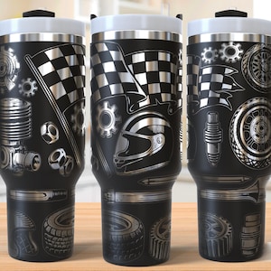 May include: Three black travel mugs with silver racing designs. Each mug has a black handle, a white lid, and racing graphics, including checkered flags, helmets, and tyres. The words "SEAMLESS DESIGN" are at the bottom.