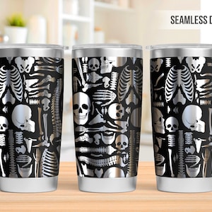 May include: Three stainless steel tumblers with a black and silver skeletal design. The design features skulls and bones.