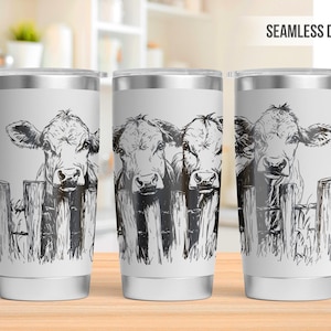May include: Three white stainless steel tumblers with a black and white illustration of three cows peeking over a fence. The text "SEAMLESS DESIGN" is in the upper right corner of the image.