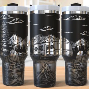 May include: Black travel mug with a camping design. The design includes a mountain range, a camper van, Adirondack chairs, a campfire, and clouds. The mug has a black handle and a white lid.