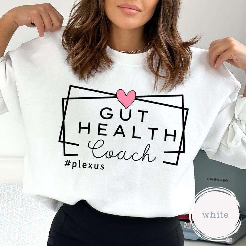May include: White sweatshirt with a black graphic that says "Gut Health Coach" with a pink heart and the hashtag "#plexus".