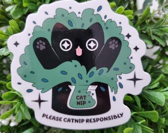 May include: A sticker depicting a black cat with white eyes and paws, surrounded by a green leafy bush. The cat holds a bag marked "CAT NIP". The text "PLEASE CATNIP RESPONSIBLY" is printed below the cat.