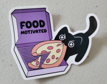 May include: A die-cut sticker featuring a black cat with star-shaped eyes holding a slice of pepperoni pizza in its mouth. Next to the cat is an open purple pizza box with the text FOOD MOTIVATED printed in bold black capital letters.