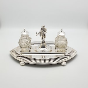 May include: A set of three ceramic mugs with a speckled, matte finish. The mugs are in shades of cream, light gray, and dark gray. Each mug has a simple, minimalist design, perfect for coffee or tea.