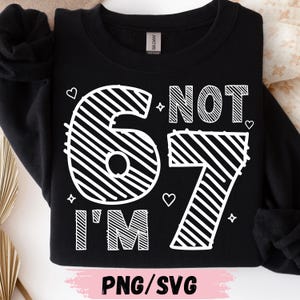 May include: Black sweatshirt with a white graphic that reads "I'M NOT 67". The numbers are stylized with diagonal lines, and the text is surrounded by hearts and stars. The bottom of the image says "PNG/SVG".