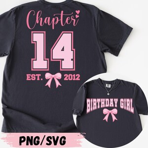 May include: Dark navy blue t-shirt with pink text and graphics. The back of the shirt says "Chapter 14" with a bow graphic and the text "EST. 2012". The front of the shirt says "BIRTHDAY GIRL" with a bow graphic.