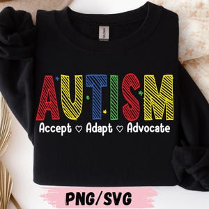 May include: Black sweatshirt with the word "AUTISM" in colorful, block letters. Below, the words "Accept ♡ Adapt ♡ Advocate" are written in white. The bottom of the image reads "PNG/SVG".