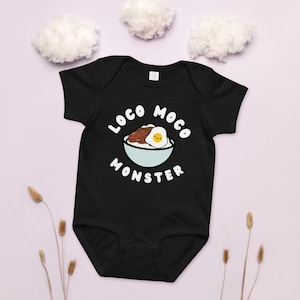 May include: Black baby bodysuit with the words "LOCO MOCO MONSTER" in white, with a cartoon illustration of a bowl of loco moco. The illustration includes rice, a hamburger patty, and a fried egg. The bodysuit is short-sleeved.