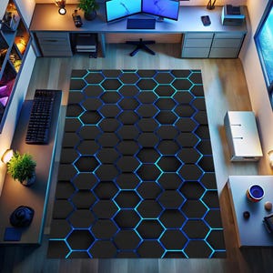 May include: A black and blue hexagonal patterned rug. The rug features a repeating pattern of dark gray hexagons with bright blue and teal outlines. The rug is placed in a home office setting, with a desk, computer monitors, and other office accessories.