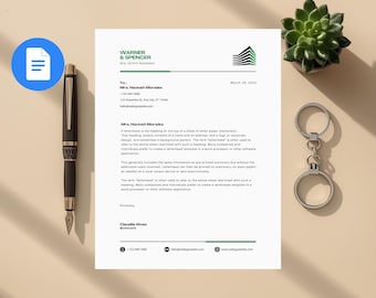 May include: A letterhead for Warner & Spencer Real Estate Residence, with a green and black logo. A black pen, a succulent plant, and a silver keychain are also present. The letterhead is addressed to Mrs. Hannah Morales.