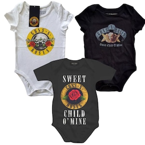 May include: Three baby onesies featuring Guns N' Roses logos. One white onesie with the Guns N' Roses logo and the words "Guns N' Roses". One black onesie with the words "Guns N' Roses Sweet Child O' Mine". One gray onesie with the words "Sweet Child O' Mine" and the Guns N' Roses logo.
