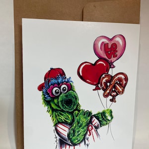 Une seule carte de voeux de Phillies Phanatic, mascotte de baseball préférée de Philadelphie, tenant des ballons d'amour et un ballon bretzel Philly
