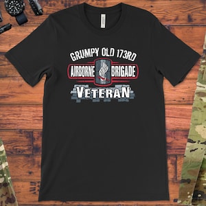 May include: Black t-shirt with a distressed graphic design that reads "Grumpy Old 173rd Airborne Brigade Veteran".