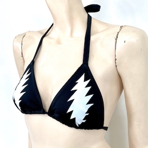 May include: Black bikini top with a white lightning bolt graphic.