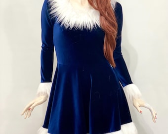 May include: A long-sleeved, navy blue velvet dress with white faux fur trim on the collar, cuffs, and hem. The dress has a flared skirt and is displayed on a mannequin. The mannequin has red hair.