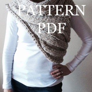 May include: A beige knitted cowl neck scarf with a textured pattern. The scarf is worn by a person and the text "PATTERN PDF" is superimposed on the image.