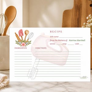 May include: A recipe card with a watercolor illustration of a hand mixer and cooking utensils. The card includes sections for dish name, ingredients, and directions. Text reads "from the kitchen of: Katrina Marshall."