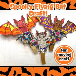 Puede incluir: Tres recortes de murciélagos de papel con pinzas de madera. Los murciélagos presentan coloridos patrones de alas estilo vidriera en rojo, naranja, morado y gris. El texto dice Spooky Flying Bat Craft! y fun moving craft.