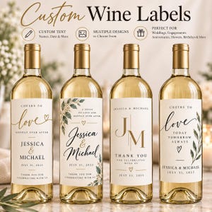 May include: Four glass wine bottles with gold foil caps, each featuring a unique custom label. The labels display various elegant typography, botanical illustrations, and text including 'Cheers to love', 'Jessica & Michael', and 'July 31, 2025'.