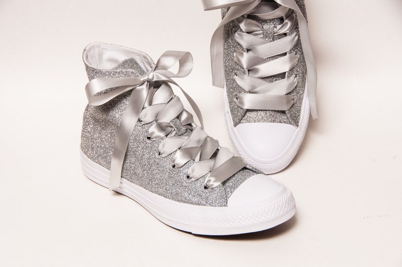 white sneakers with silver stars