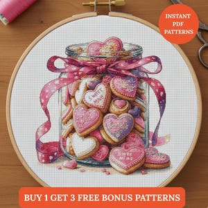 May include: Cross-stitch pattern of a jar filled with heart-shaped cookies. The cookies are pink, white, and purple with text that reads "Sweet Mine" and "Be Mine". The jar is tied with a pink ribbon. The text "Instant PDF Patterns" and "Buy 1 Get 3 Free Bonus Patterns" are also visible.