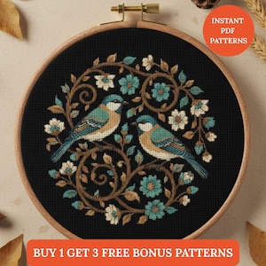 May include: Cross-stitch pattern featuring two blue and tan birds perched amidst teal and white flowers and brown vines, set against a black background. The design is framed in a wooden embroidery hoop. Text reads "INSTANT PDF PATTERNS" and "BUY 1 GET 3 FREE BONUS PATTERNS".