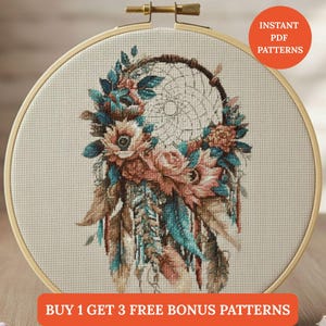 May include: Cross-stitch pattern of a dreamcatcher with floral and feather details. The design features pink, teal, and brown colors, set within a wooden embroidery hoop. Text on the image reads "INSTANT PDF PATTERNS" and "BUY 1 GET 3 FREE BONUS PATTERNS".