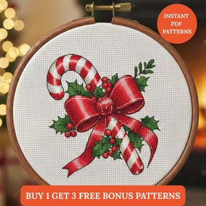 May include: A cross-stitch pattern of a candy cane, red bow, holly, and berries, set in a wooden embroidery hoop. The candy cane has red and white stripes. The text "INSTANT PDF PATTERNS" and "BUY 1 GET 3 FREE BONUS PATTERNS" are visible.