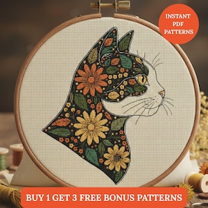 May include: Cross-stitch pattern of a cat profile, adorned with floral designs in orange, yellow, and green. The cat is set within a wooden embroidery hoop. Text reads "Instant PDF Patterns" and "Buy 1 Get 3 Free Bonus Patterns".