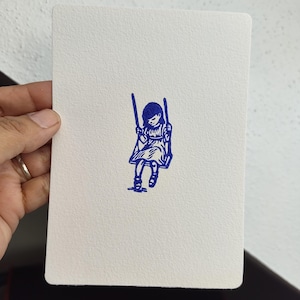 Peut inclure: Une feuille de papier blanc texturé de forme rectangulaire présentant une illustration centrée à l'encre bleu foncé représentant un enfant aux cheveux mi-longs assis sur une balançoire. Le dessin est réalisé dans un style linéaire simple.