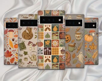 May include: Five phone cases with autumn-themed designs. Each case features a different pattern, including pumpkins, leaves, mushrooms, and plaid squares. The cases are in shades of orange, brown, and beige, with a white background.