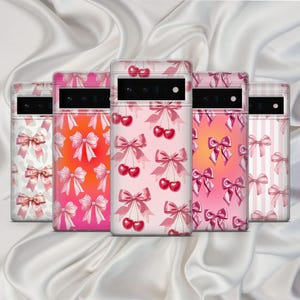May include: Four different phone cases with pink and red cherry and bow designs.