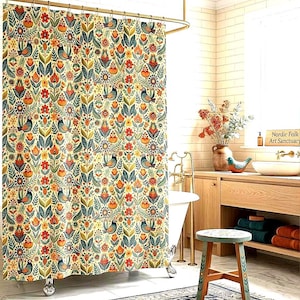 May include: A floral shower curtain with a cream background, featuring a repeating pattern of birds, flowers, and leaves in shades of orange, green, and blue. The curtain hangs in a bathroom with a white tub and wooden accents.
