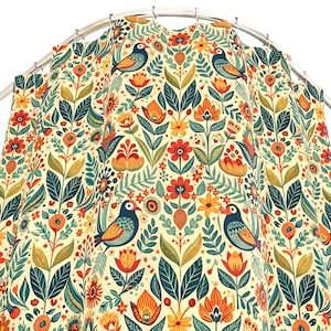 May include: A colorful shower curtain featuring a repeating pattern of stylized birds, flowers, and foliage in shades of teal, orange, red, and yellow on a cream background. The design includes detailed floral and bird illustrations, creating a vibrant and decorative bathroom accessory.