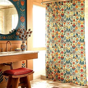 May include: A bathroom with a decorative theme. The focal point is a floral patterned shower curtain with birds, flowers, and leaves in orange, blue, and green. A wooden vanity, mirror, and stool complement the design. A patterned rug adds to the room's aesthetic.