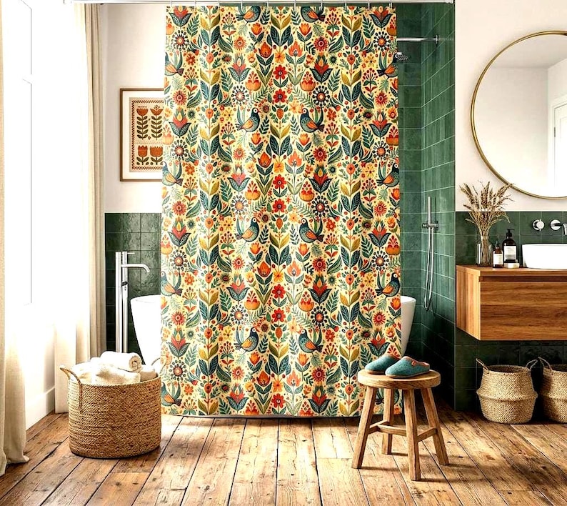 May include: A floral patterned shower curtain with birds, flowers, and leaves in shades of red, orange, green, and blue. The curtain is hanging in a bathroom with a wooden floor and a round mirror.