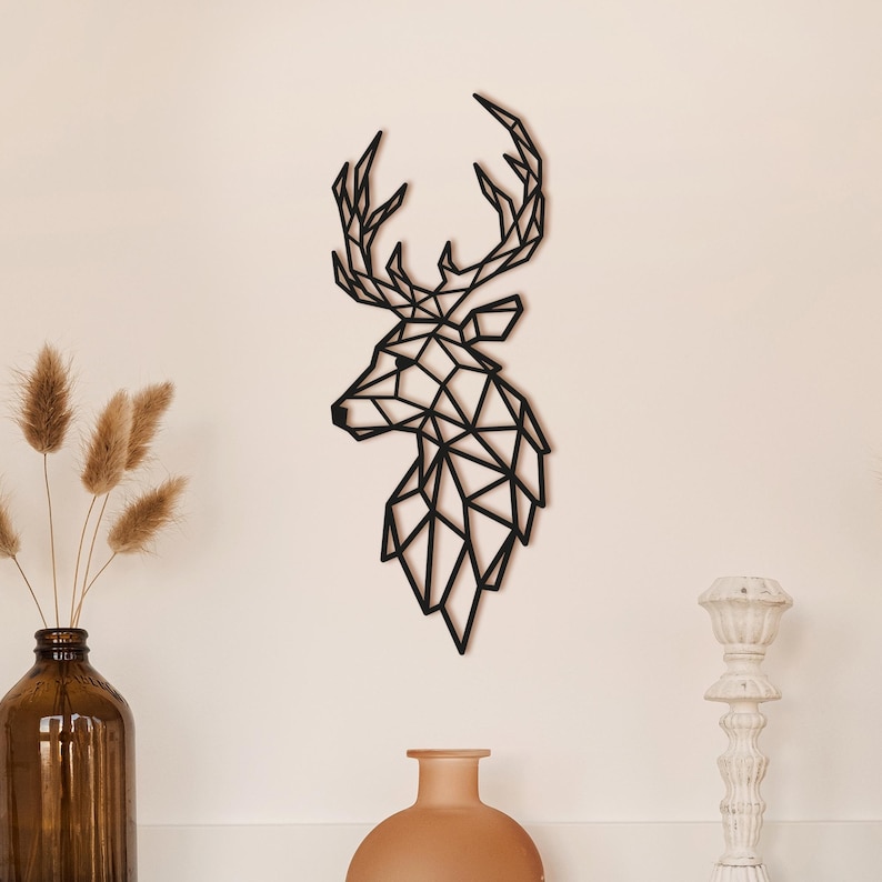 May include: Black geometric deer head wall decor. The deer head is made of metal and has a modern, minimalist design.