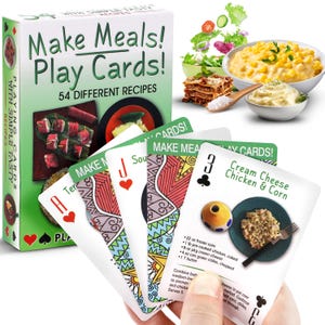 May include: A deck of playing cards with colorful designs and recipes for simple meals. The cards feature a variety of dishes, including a cream cheese chicken and corn recipe. The box for the cards says "Make Meals! Play Cards! 54 Different Recipes".