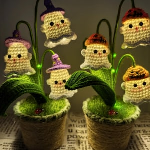 May include: Two crochet ghost flower arrangements in twine-wrapped pots. Each ghost wears a different coloured hat and has a smiling face. The green stems have small green lights. The pots sit on a newspaper.