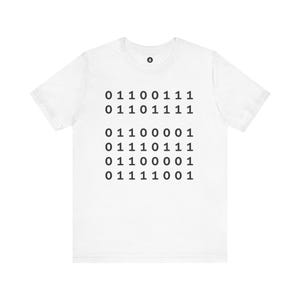 May include: A white short-sleeved t-shirt featuring a black graphic print of binary code arranged in six rows. The binary sequence reads 01100111, 01101111, 01100001, 01110111, 01100001, and 01111001. A small circular logo is centered at the neckline.