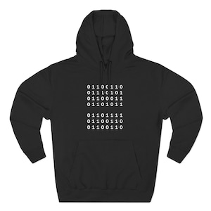 May include: A black hooded sweatshirt featuring a white graphic print of binary code on the chest. The hoodie includes long sleeves, a front kangaroo pocket, and a drawstring hood. The binary sequence consists of seven rows of zeros and ones.