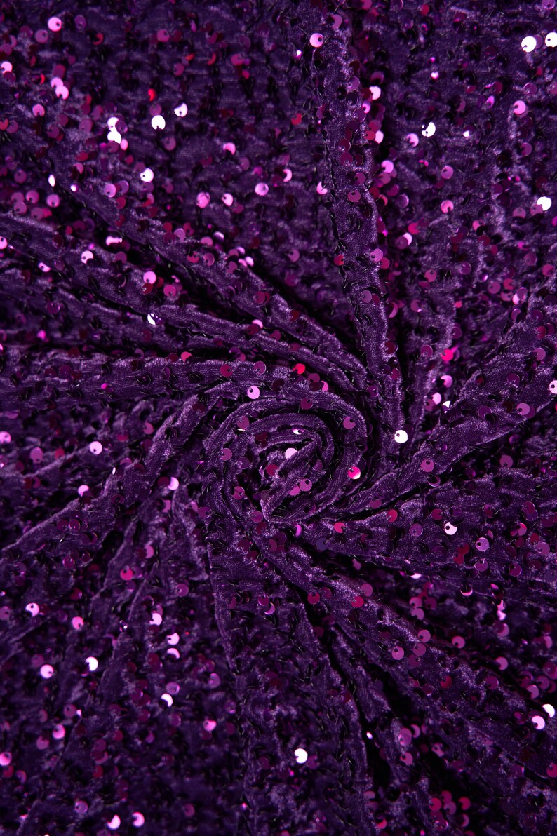 May include: Purple velvet fabric with a swirl pattern and small, round sequins.