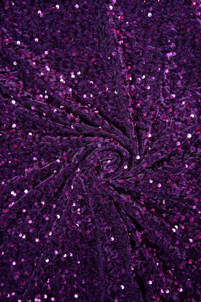 May include: Purple velvet fabric with sequins. The fabric is gathered in a swirl pattern.