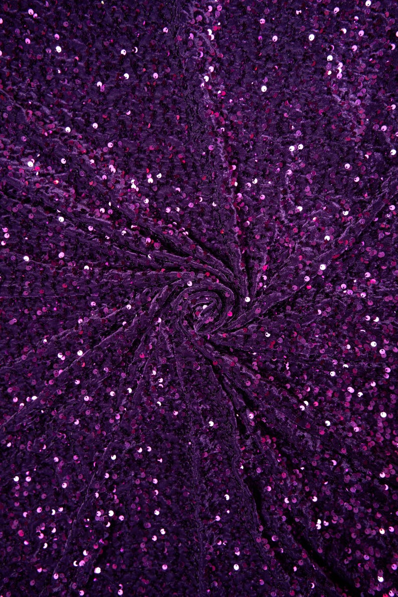 May include: Purple velvet fabric with sequins. The fabric has a swirling pattern and is covered in small, round sequins.