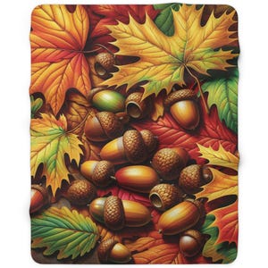 May include: A blanket featuring a vibrant autumn design. The blanket is covered with colorful fall leaves in shades of red, orange, and yellow, along with numerous acorns. The design evokes a cozy, seasonal theme.