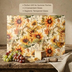 Pode incluir: Uma tábua de corte retangular de vidro temperado com um padrão de girassóis. O texto diz: Perfect Gift for Summer Parties, 2 Convenient Sizes, Hygienic Tempered Glass. É apresentada com uvas, queijo e uma faca.