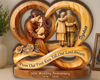 May include: A wooden-textured decorative sculpture featuring an infinity heart shape. It depicts a young couple kissing and an elderly couple embracing. Text includes "James", "Sophia", "From Our First Kiss Till Our Last Breath", and "50th Wedding Anniversary 1976 - 2026".