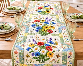 May include: A floral table runner with a quilted design. The runner features a cream background with colorful bouquets of flowers, including red poppies, yellow sunflowers, and blue daisies. Butterflies and a green border complete the design.