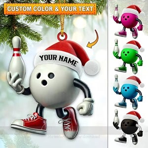 May include: A bowling ball Christmas ornament with a Santa hat that says "YOUR NAME". The ornament is white, red, and black, with a bowling pin in its hand. The image also shows other color variations.