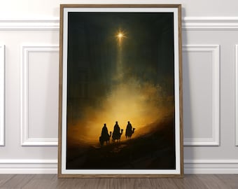 May include: Framed art print showing three figures on camels, silhouetted against a warm, golden light. A bright star shines above, illuminating the scene. The artwork is framed in a wooden frame.